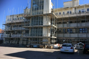 Showing building number 2 being renoved with scaffolding before work to clean it